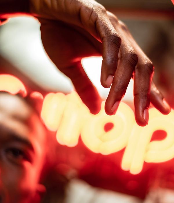 Person in a dynamic cardio pose against a dark background with red light trails.